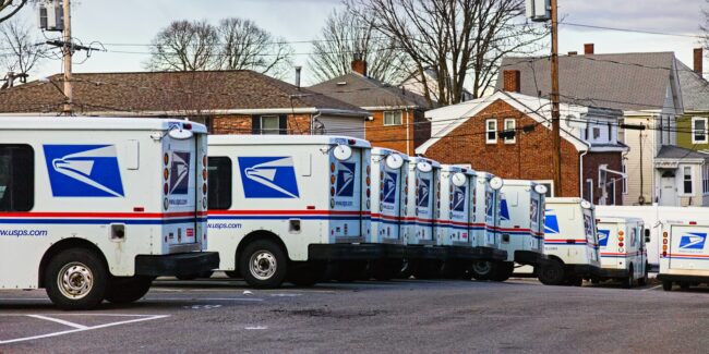 USPS trucks lined up in a row