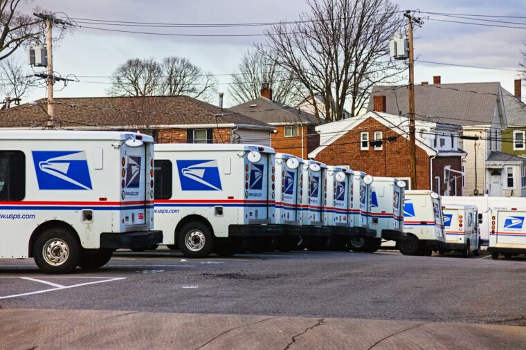 USPS trucks lined up in a row