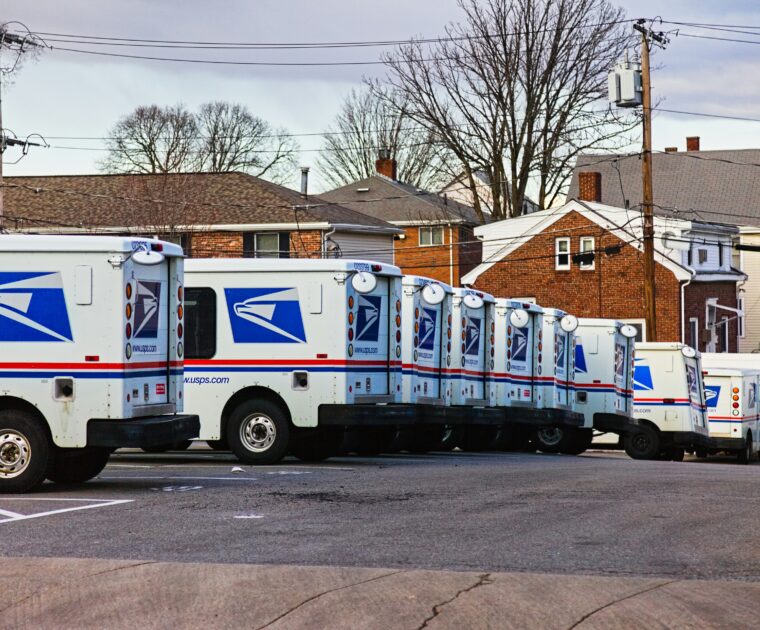 USPS trucks lined up in a row